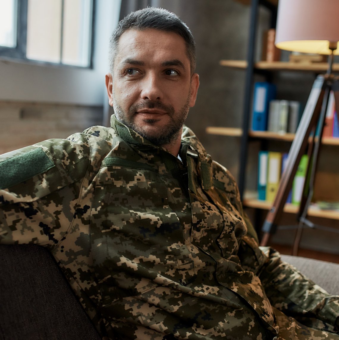 White servicemember in his home.